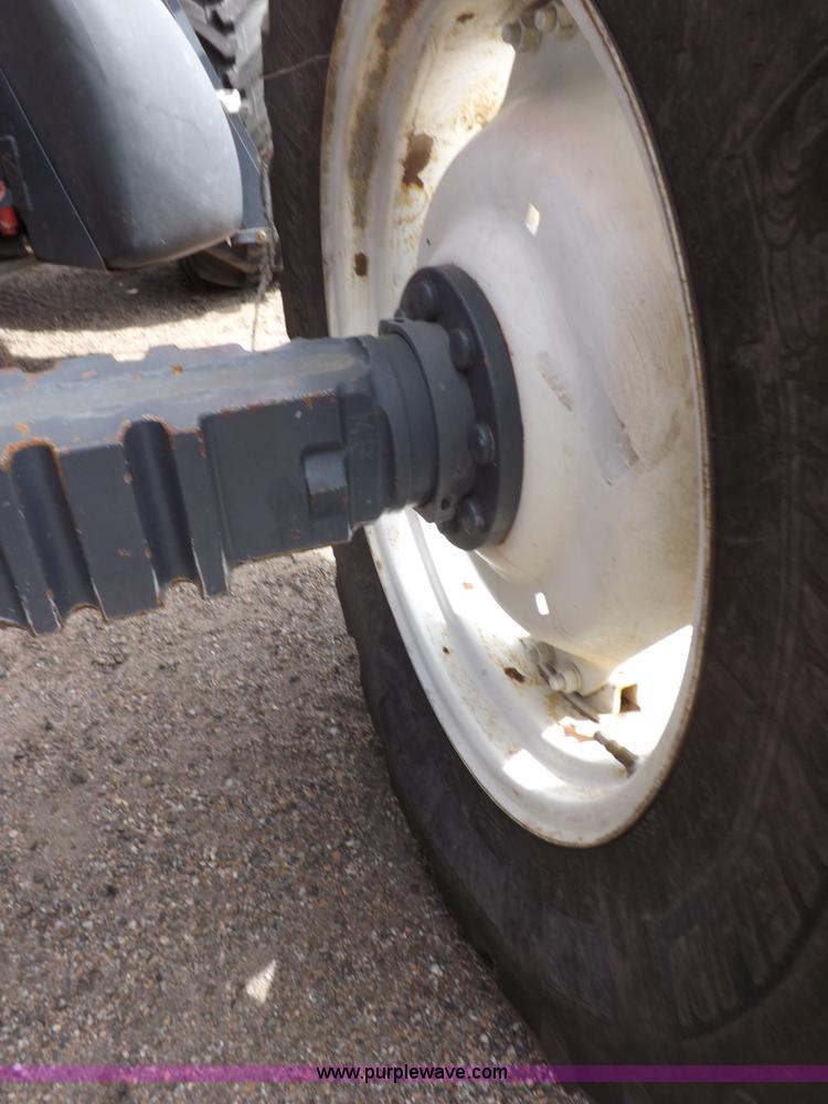 image for item H9106 1999 New Holland TV140 bi-directional MFWD tractor