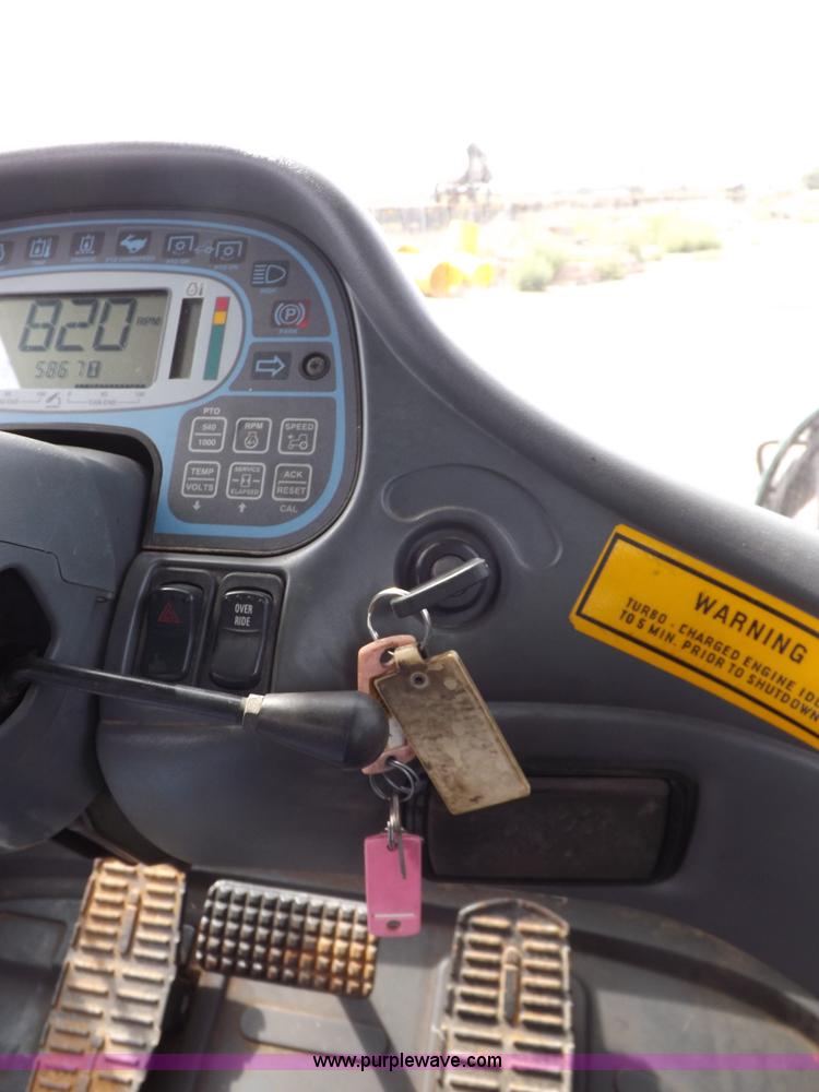 image for item H9107 1999 New Holland TV140 bi-directional MFWD tractor