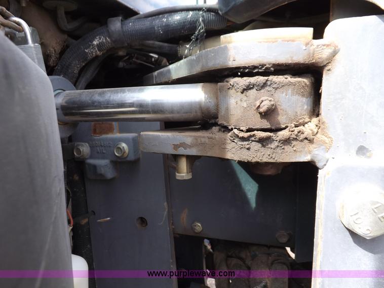 image for item H9107 1999 New Holland TV140 bi-directional MFWD tractor