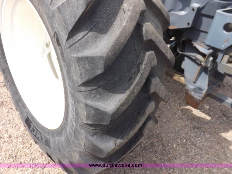 image for item H9107 1999 New Holland TV140 bi-directional MFWD tractor