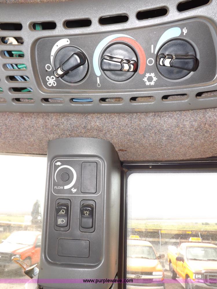 image for item H9112 1999 New Holland TV140 bi-directional MFWD tractor