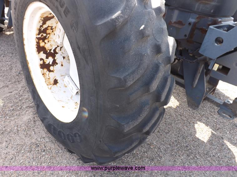 image for item H9112 1999 New Holland TV140 bi-directional MFWD tractor