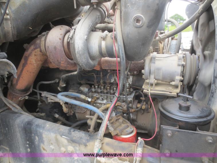 image for item D2145 1985 Mack DM686S roll off truck