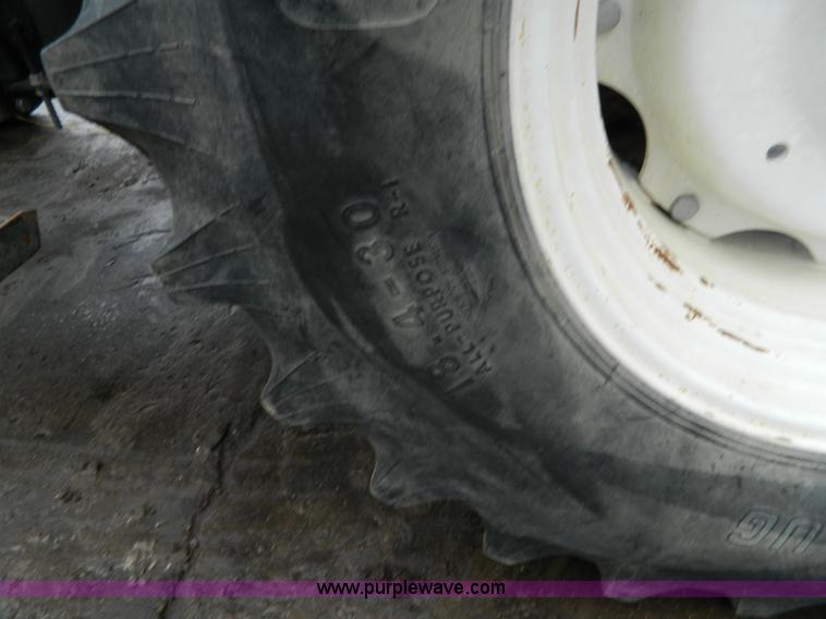 image for item H2306 2002 New Holland TL100 tractor