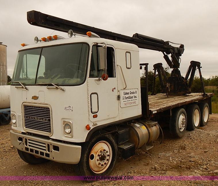 image for item J3092 1975 Chevrolet flatbed truck with crane