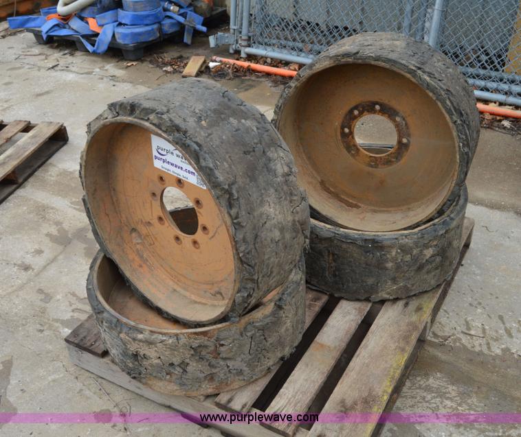 image for item I6945 Eight lug skid steer solid wheels and tires