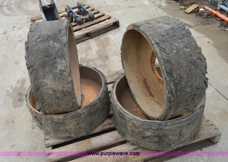 image for item I6945 Eight lug skid steer solid wheels and tires