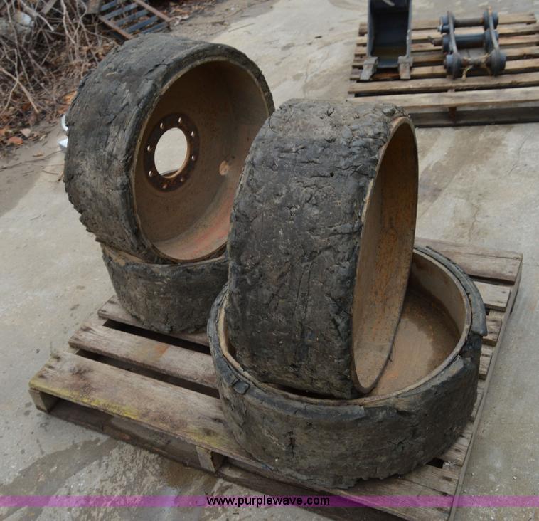 image for item I6945 Eight lug skid steer solid wheels and tires