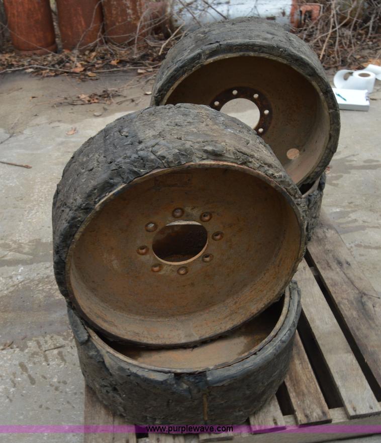 image for item I6945 Eight lug skid steer solid wheels and tires