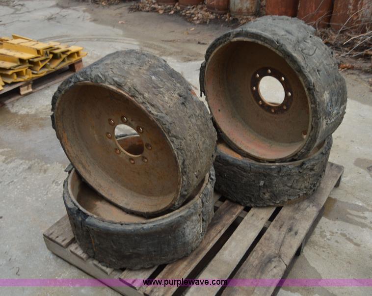 image for item I6945 Eight lug skid steer solid wheels and tires