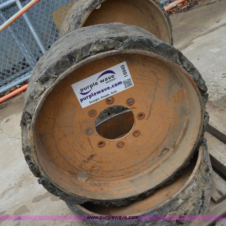 image for item I6945 Eight lug skid steer solid wheels and tires