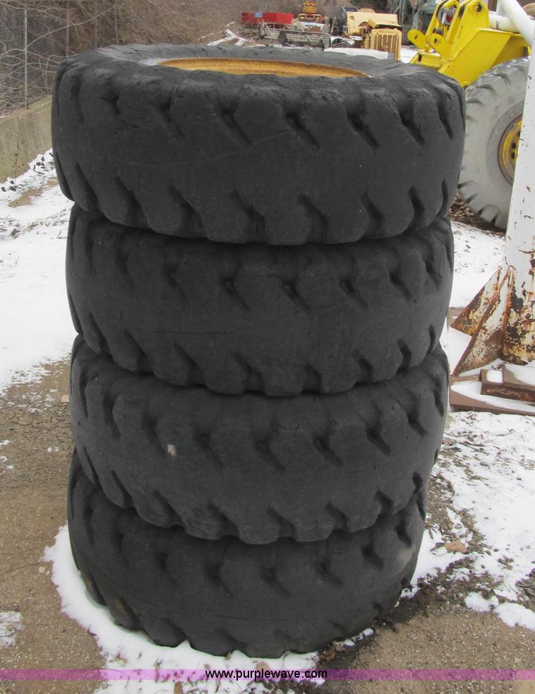 image for item F8930 (4) 17.5R25 tires and wheels