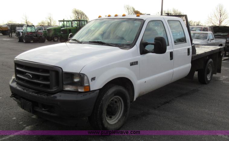 image for item AW9105 2002 Ford F350 Super Duty XL Crew Cab flatbed truck