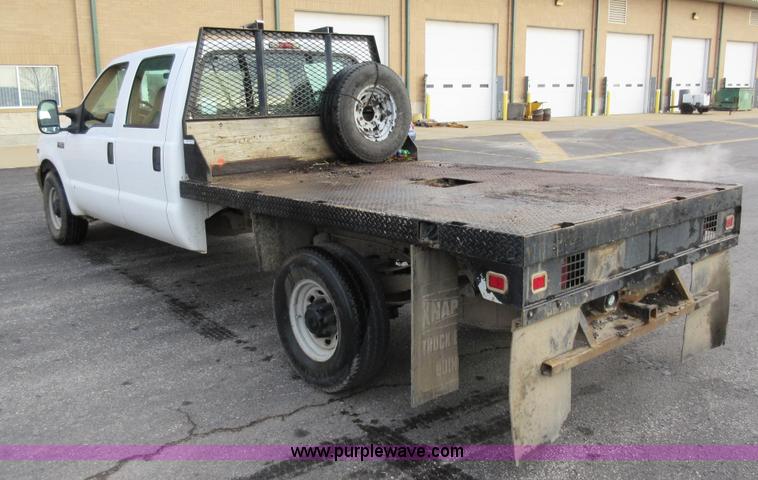 image for item AW9105 2002 Ford F350 Super Duty XL Crew Cab flatbed truck