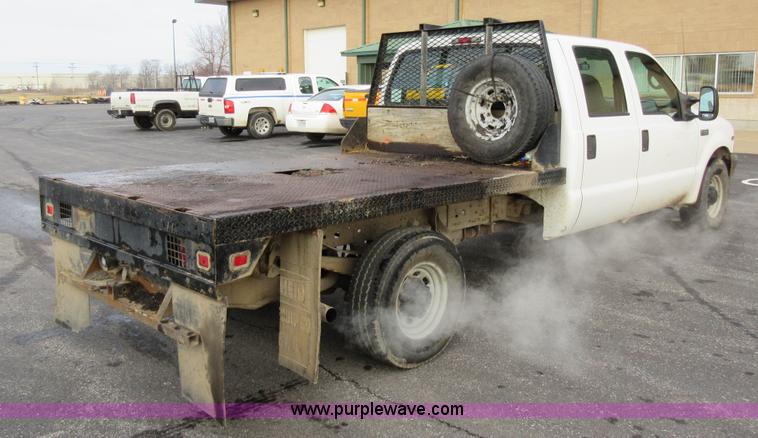 image for item AW9105 2002 Ford F350 Super Duty XL Crew Cab flatbed truck