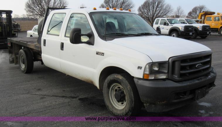 image for item AW9105 2002 Ford F350 Super Duty XL Crew Cab flatbed truck