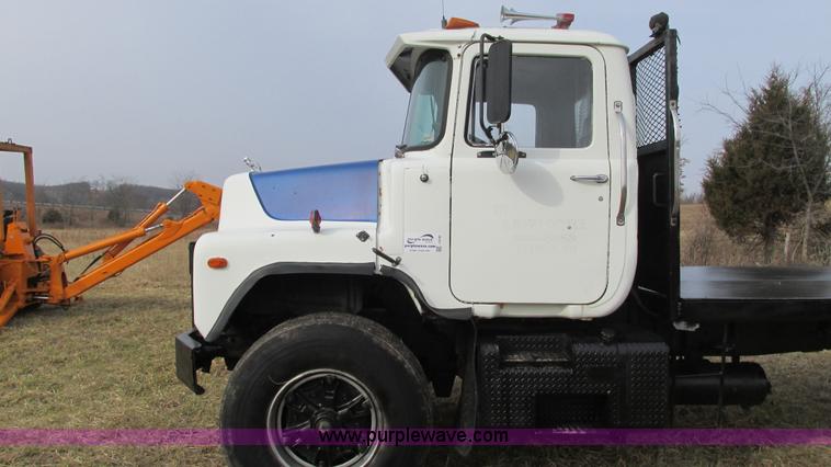 image for item I3120 1987 Mack DM686S flatbed truck