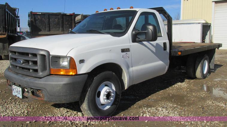 image for item H7613 1999 Ford F350 Super Duty XL flatbed pickup truck