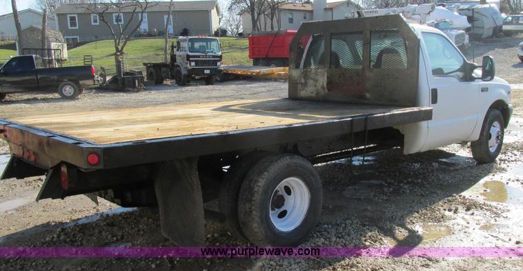 image for item H7613 1999 Ford F350 Super Duty XL flatbed pickup truck