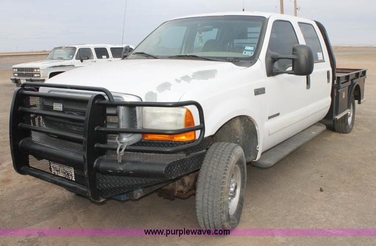image for item H1595 2001 Ford F350 Super Duty Crew Cab flatbed truck