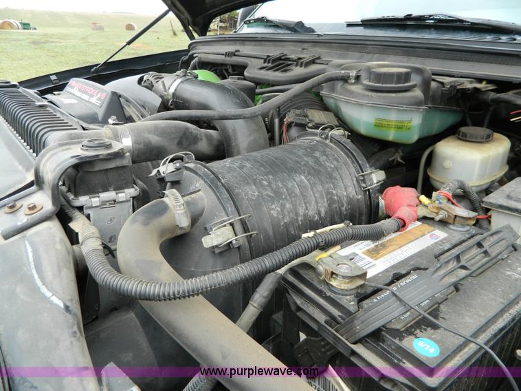 image for item D6119 2004 Ford F250 Super Duty SuperCab flatbed pickup truck