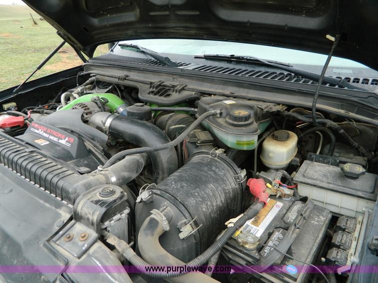 image for item D6119 2004 Ford F250 Super Duty SuperCab flatbed pickup truck