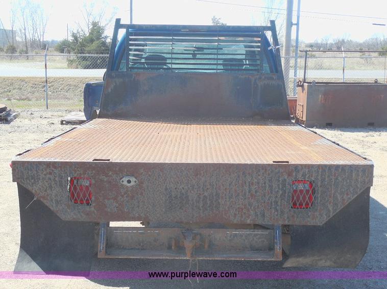 image for item E6311 2002 Ford F250 Super Duty SuperCab flatbed pickup truck