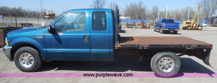image for item E6311 2002 Ford F250 Super Duty SuperCab flatbed pickup truck