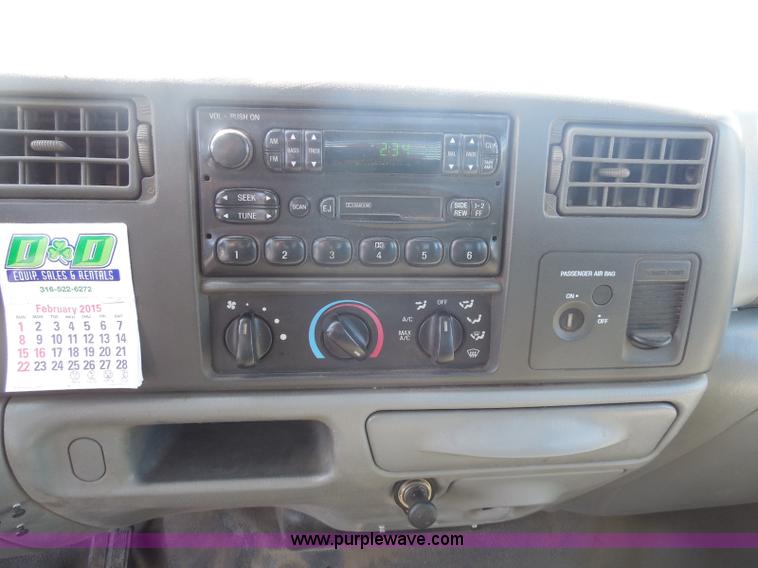 image for item E6311 2002 Ford F250 Super Duty SuperCab flatbed pickup truck