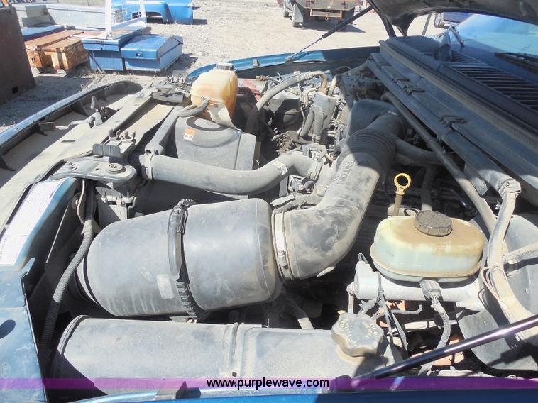 image for item E6311 2002 Ford F250 Super Duty SuperCab flatbed pickup truck