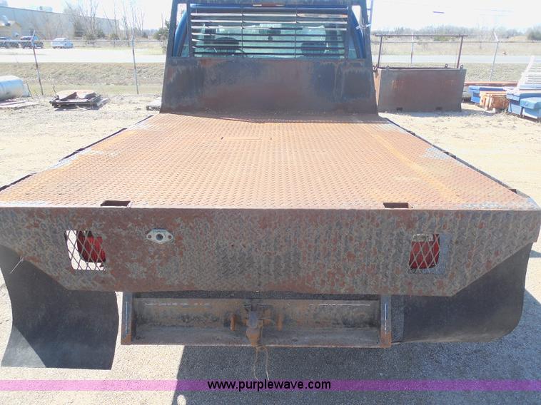 image for item E6311 2002 Ford F250 Super Duty SuperCab flatbed pickup truck