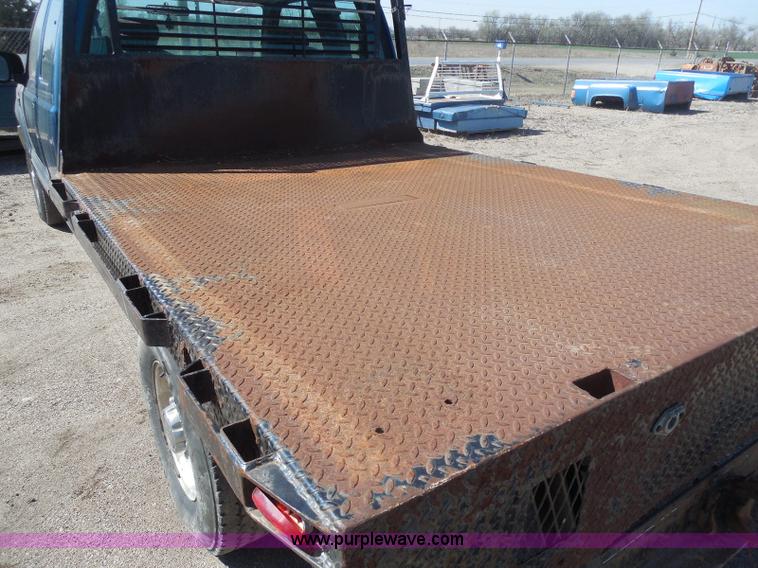 image for item E6311 2002 Ford F250 Super Duty SuperCab flatbed pickup truck