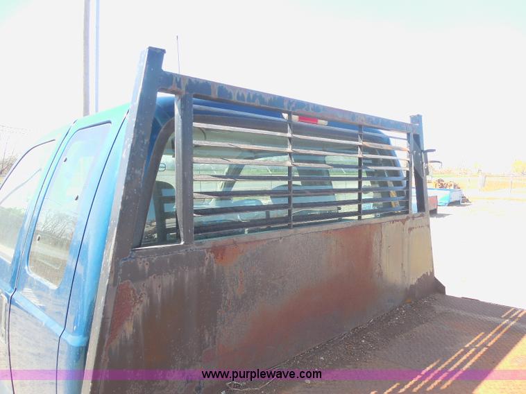 image for item E6311 2002 Ford F250 Super Duty SuperCab flatbed pickup truck