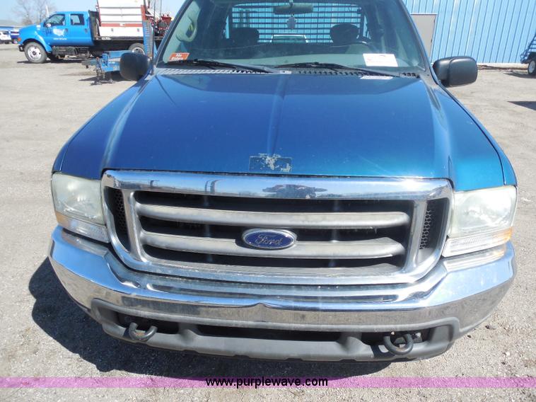 image for item E6311 2002 Ford F250 Super Duty SuperCab flatbed pickup truck