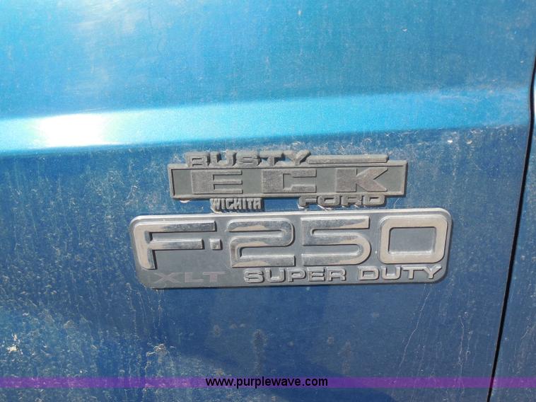 image for item E6311 2002 Ford F250 Super Duty SuperCab flatbed pickup truck