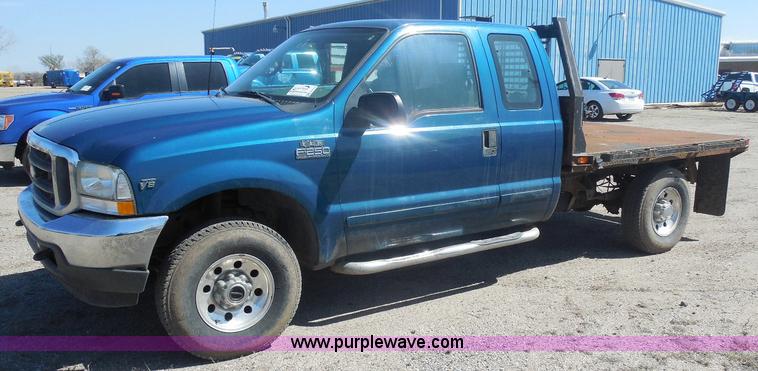 image for item E6312 2002 Ford F250 Super Duty SuperCab flatbed pickup truck