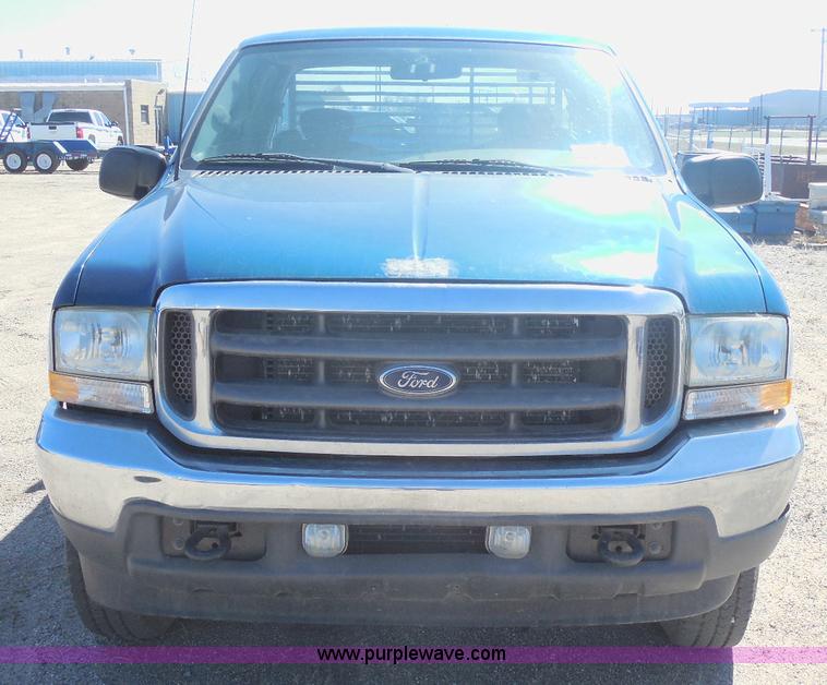 image for item E6312 2002 Ford F250 Super Duty SuperCab flatbed pickup truck