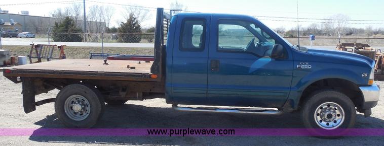 image for item E6312 2002 Ford F250 Super Duty SuperCab flatbed pickup truck