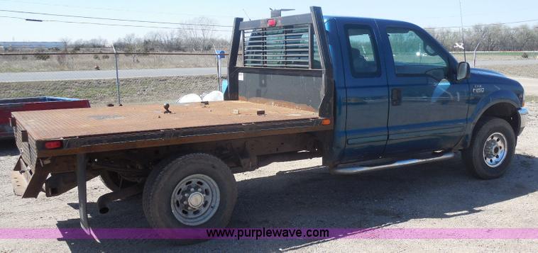 image for item E6312 2002 Ford F250 Super Duty SuperCab flatbed pickup truck
