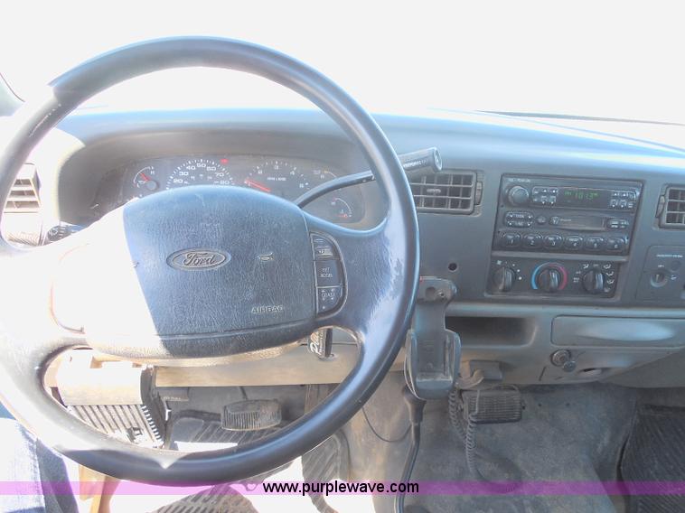 image for item E6312 2002 Ford F250 Super Duty SuperCab flatbed pickup truck