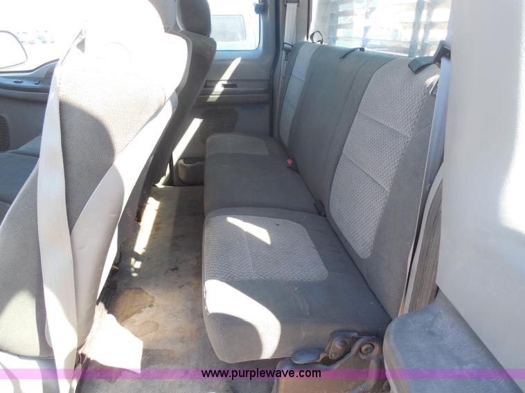 image for item E6312 2002 Ford F250 Super Duty SuperCab flatbed pickup truck