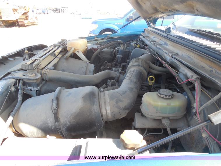 image for item E6312 2002 Ford F250 Super Duty SuperCab flatbed pickup truck