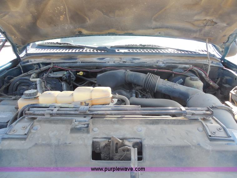 image for item E6312 2002 Ford F250 Super Duty SuperCab flatbed pickup truck