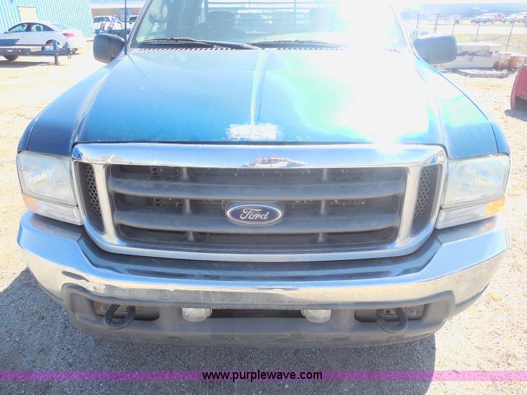 image for item E6312 2002 Ford F250 Super Duty SuperCab flatbed pickup truck