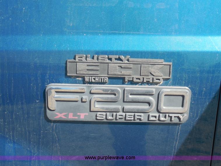 image for item E6312 2002 Ford F250 Super Duty SuperCab flatbed pickup truck