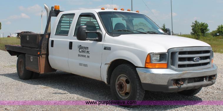 image for item H5794 1999 Ford F350 Super Duty XL Crew Cab flatbed pickup truck