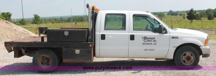 image for item H5794 1999 Ford F350 Super Duty XL Crew Cab flatbed pickup truck