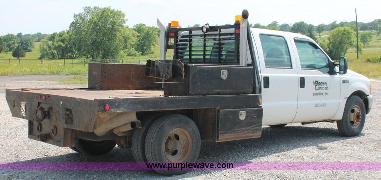 image for item H5794 1999 Ford F350 Super Duty XL Crew Cab flatbed pickup truck