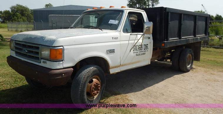 image for item J3860 1991 Ford F450 Super Duty XL flatbed dump truck