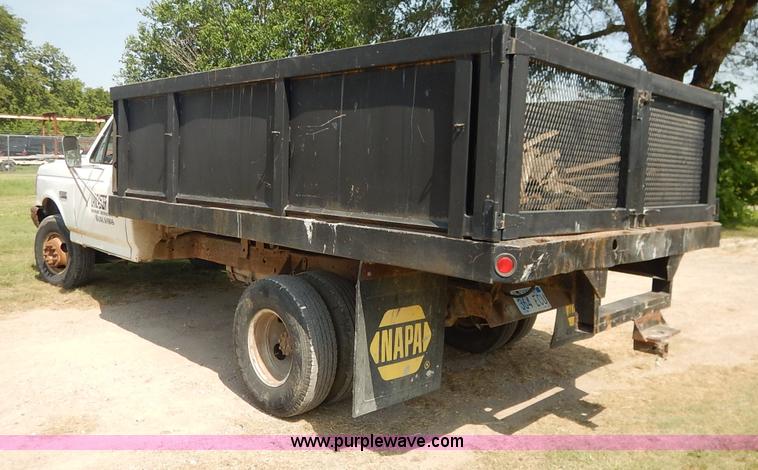image for item J3860 1991 Ford F450 Super Duty XL flatbed dump truck